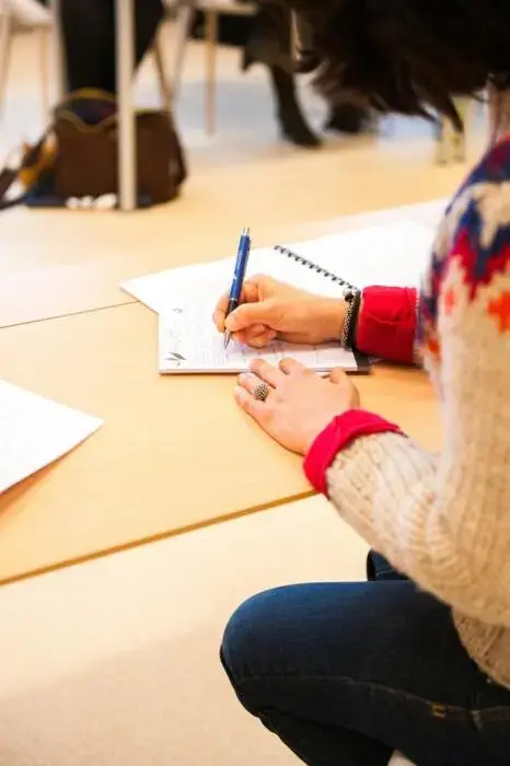 person taking notes at a table