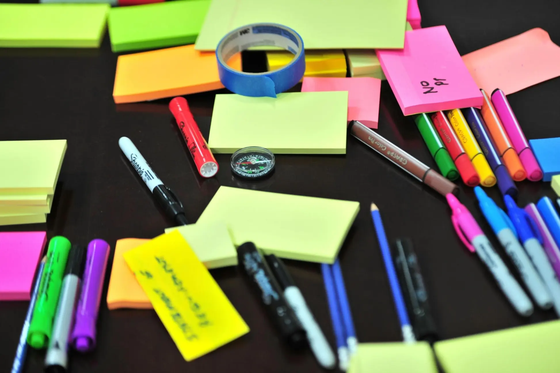 coloured highlighters and sticky notes on a table